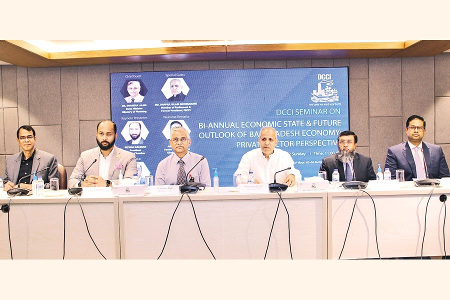 State Minister for Planning Dr Shamsul Alam (3rd from left) at the Dhaka Chamber of Commerce and Industry (DCCI)-organised seminar in the city on Sunday where DCCI President Rizwan Rahman presented a keynote paper