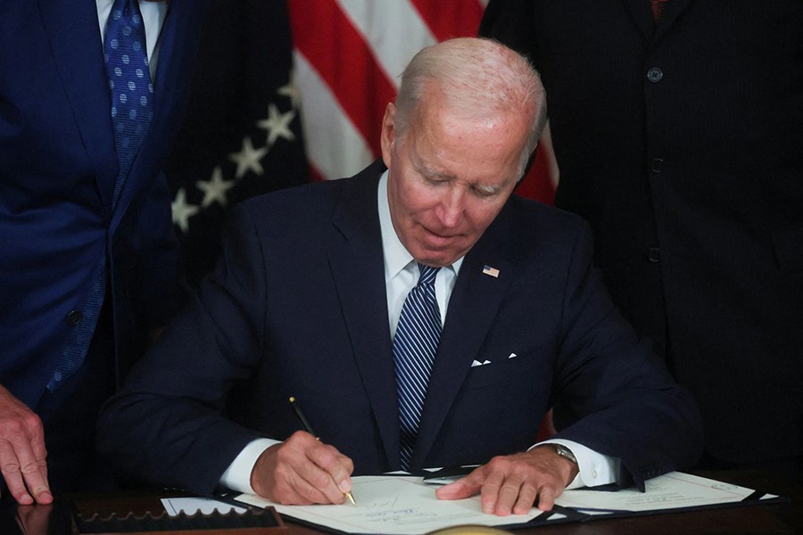 US President Joe Biden signs "The Inflation Reduction Act of 2022" into law during a ceremony in the State Dining Room of the White House in Washington, US on August 16, 2022 — Reuters photo