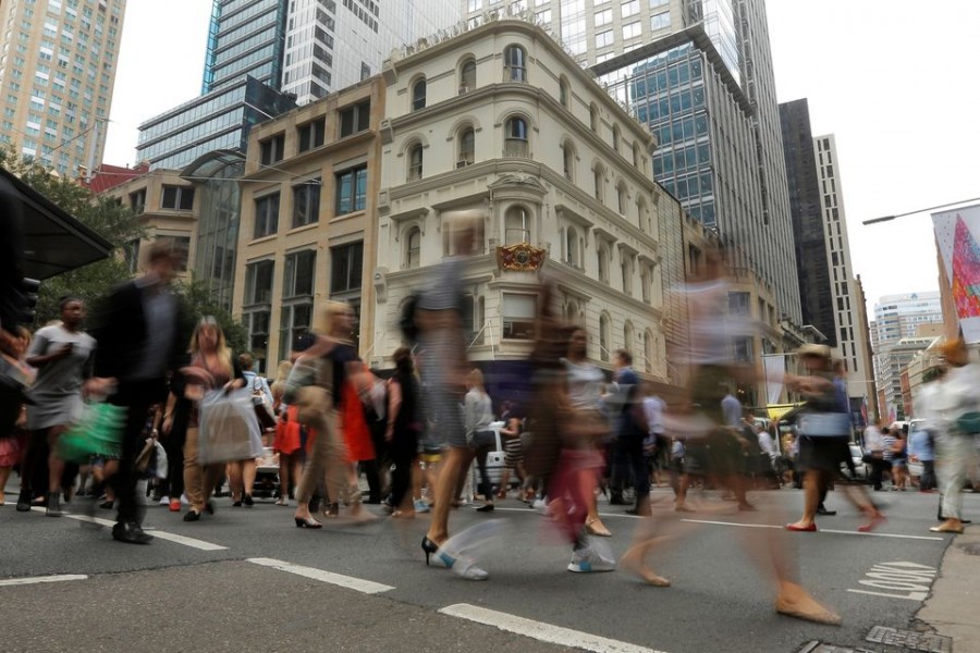 Office workers walk the streets of Sydney, Australia December 7, 2016 — Reuters/Files