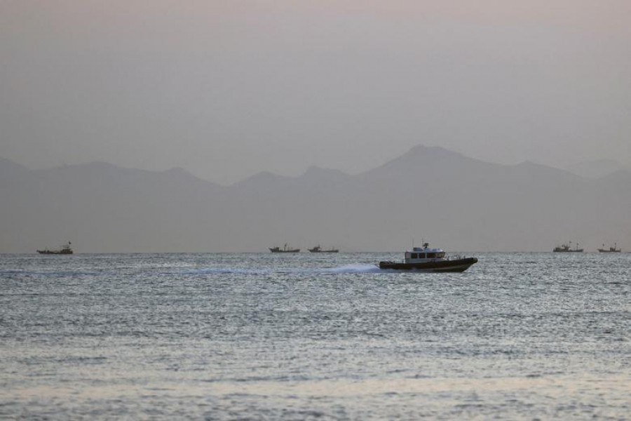 FILE PHOTO: A Taiwan Coast Guard ship travels past the coast of China, in the waters off Nangan island of Matsu archipelago in Taiwan August 16, 2022. REUTERS/Ann Wang