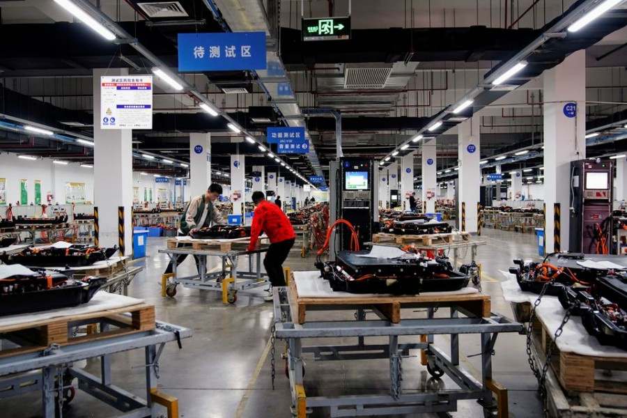 Employees work on the production line of electric vehicle (EV) battery manufacturer Octillion in Hefei, Anhui province, China March 30, 2021. Picture taken March 30, 2021. REUTERS/Aly Song