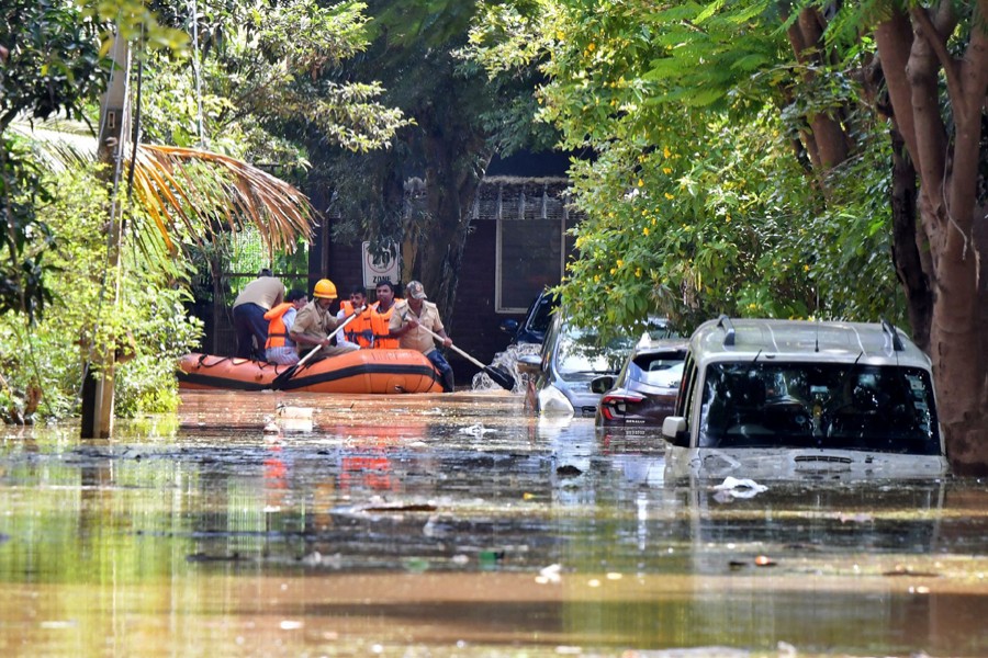 Members of a rescue team row their boat past submerged vehicles following torrential rains in Bengaluru, India on September 5, 2022 — Reuters photo