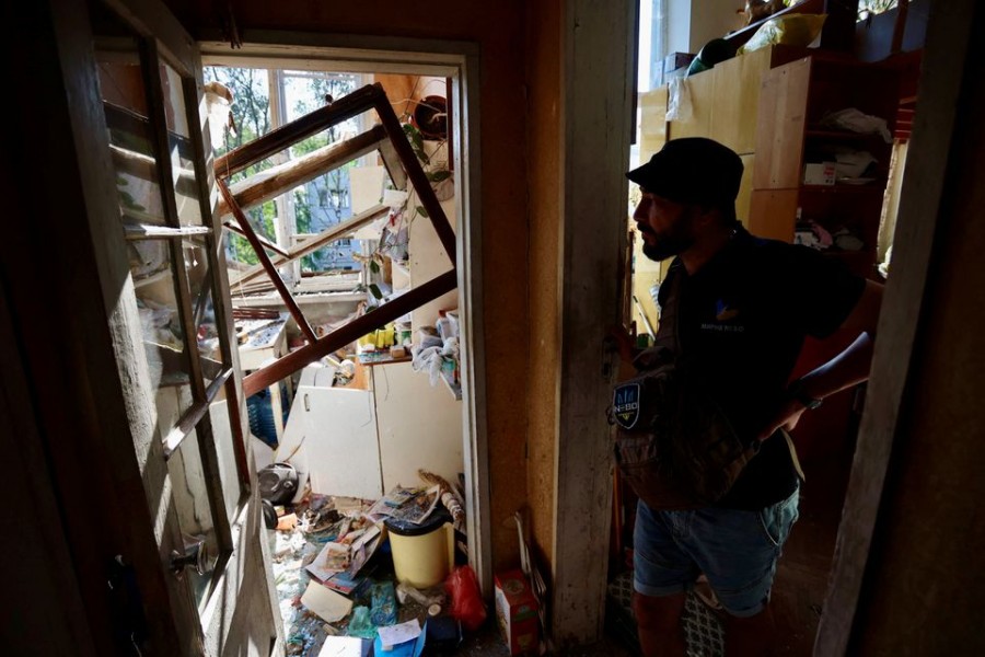 A local resident Oleksii Mazurchuk inspects his apartment in a residential building destroyed by Russian military strike, as Russia's attack on Ukraine continues, in central Kharkiv, Ukraine Aug 31, 2022. REUTERS