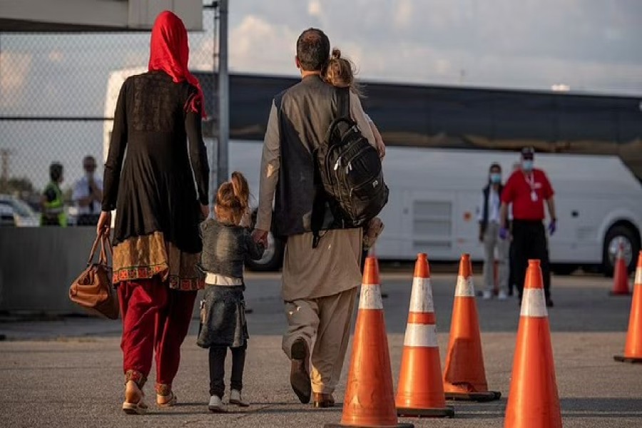 Afghan refugees who supported Canada's mission in Afghanistan prepare to board buses after arriving in Canada, at Toronto Pearson International Airport Aug 24, 2021.MCpl Genevieve Lapointe/ Canadian Forces Combat Camera/Canadian Armed Forces Photo/Handout via REUTERS