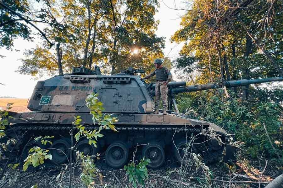 A Ukrainian service member standing on a Russian 2S19 Msta-S self-propelled howitzer captured during a counteroffensive operation in Kharkiv region of Ukraine recently –Reuters file photo