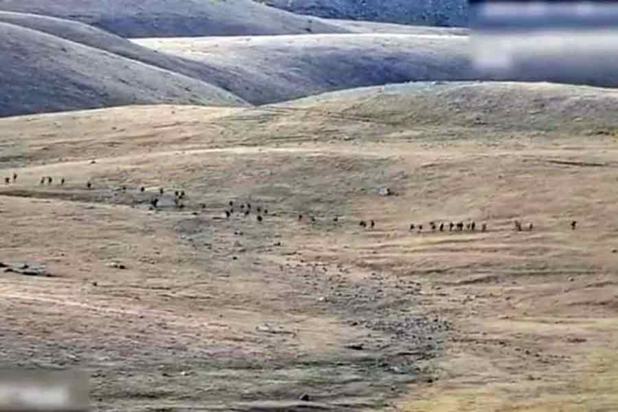 This still image from a handout footage, released on Tuesday, shows Azerbaijani service members are moving along an unidentified mountainous border area with Armenia.