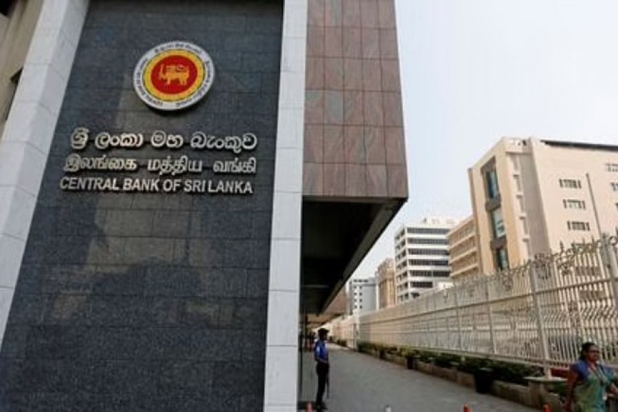 A woman walks past the main entrance of Sri Lanka's Central Bank in Colombo, Sri Lanka Feb 7, 2017. REUTERS/Dinuka Liyanawatte