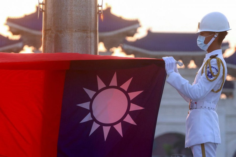 Honour guards lower the Taiwan flag during sunset hours at Liberty Square in Taipei, Taiwan, July 28, 2022. REUTERS/Ann Wang/File Photo