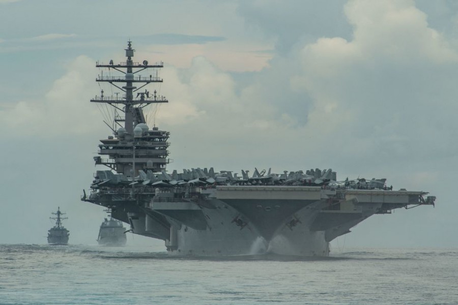 From right, the Nimitz-class aircraft carrier USS Ronald Reagan (CVN 76), the Japan Maritime Self-Defense Force Akizuki-class destroyer JS Teruzuki (DD 116) and the Arleigh Burke-class destroyer USS Mustin (DDG 89) sail in formation in the Philippine Sea, July 19, 2020. Picture taken July 19. 2020. US Navy photo by Mass Communication Specialist 3rd Class James Hong/Handout via REUTERS