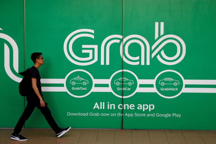 A man walks past a Grab office in Singapore March 26, 2018. REUTERS/Edgar Su