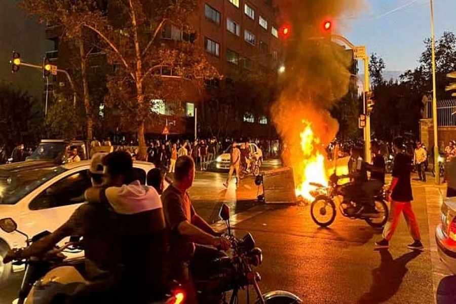 A police motorcycle burns during a protest over the death of Mahsa Amini, a woman who died after being arrested by the Islamic republic's "morality police", in Tehran, Iran September 19, 2022. WANA (West Asia News Agency) via REUTERS//File Photo