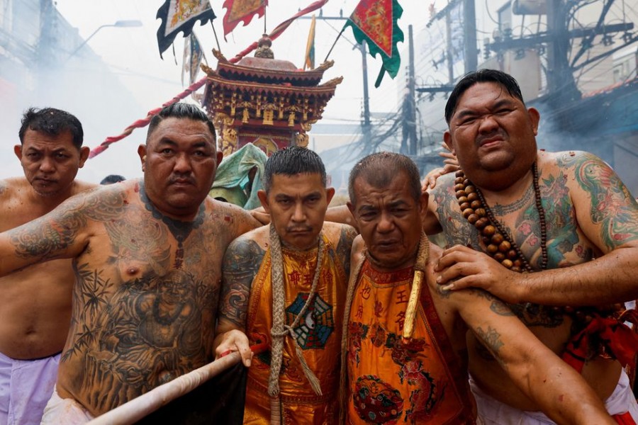 People take part in the Bang Neow Shrine procession during the annual vegetarian festival, observed by Taoist devotees from the Thai-Chinese community in the ninth lunar month of the Chinese calendar, in Phuket, Thailand October 1, 2022. REUTERS/Jorge Silva