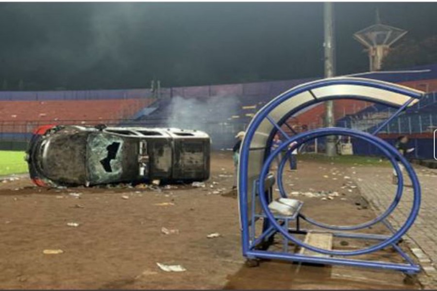 A damaged car is pictured following a riot after the league BRI Liga 1 football match between Arema vs Persebaya at Kanjuruhan Stadium, Malang, East Java province, Indonesia, October 2, 2022, in this photo taken by Antara Foto. Antara Foto/Ari Bowo Sucipto/via REUTERS Antara Foto/via REUTERS