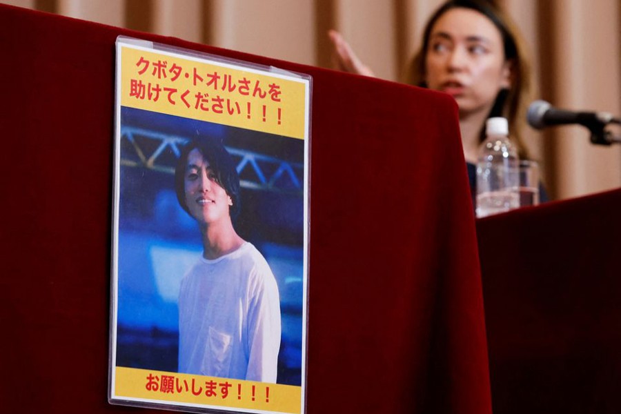 A portrait photo of Japanese documentary filmmaker Toru Kubota, who has been detained in Myanmar after filming a protest that took place on July 30, 2022, is displayed during a news conference by his friends including a radio personality Nikki Tsukamoto Kininmonth to call for his release at Japan National Press Club in Tokyo, Japan on August 3, 2022 — Reuters/Files