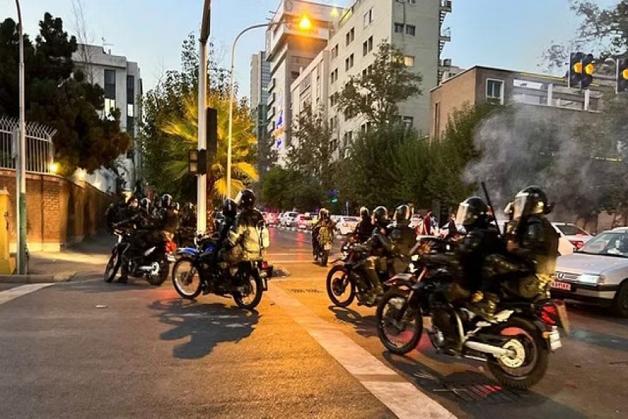 Police arrive to disperse demonstrators during a protest over the death of Mahsa Amini, a woman who died after being arrested by the Islamic republic's "morality police", in Tehran, Iran Sept 19, 2022. WANA (West Asia News Agency) via REUTERS