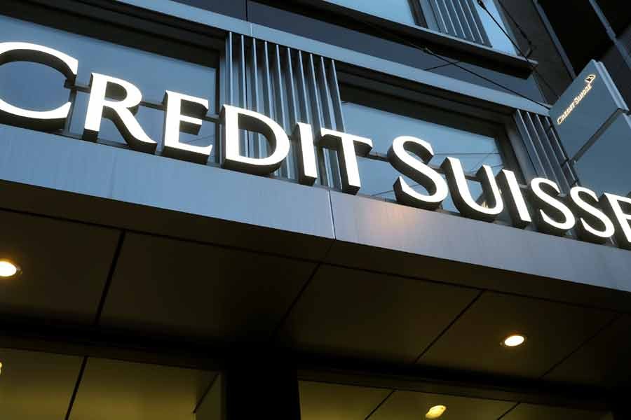 Credit Suisse pays down debt to calm investors