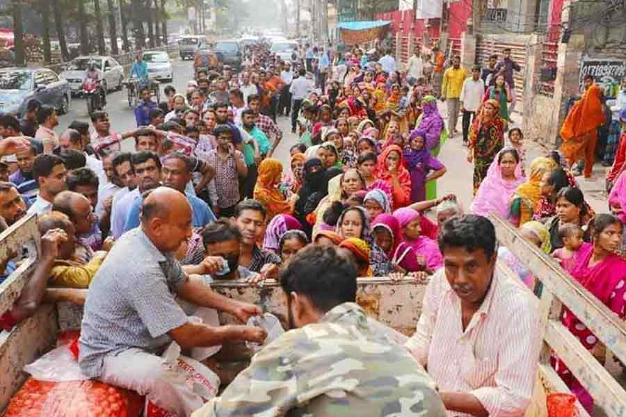 People wait in long queues to buy daily essentials at subsidised prices from a Trading Corporation of Bangladesh (TCB) truck in Dhaka as inflation soared. Now, only cardholders can buy TCB goods —UNB Photo