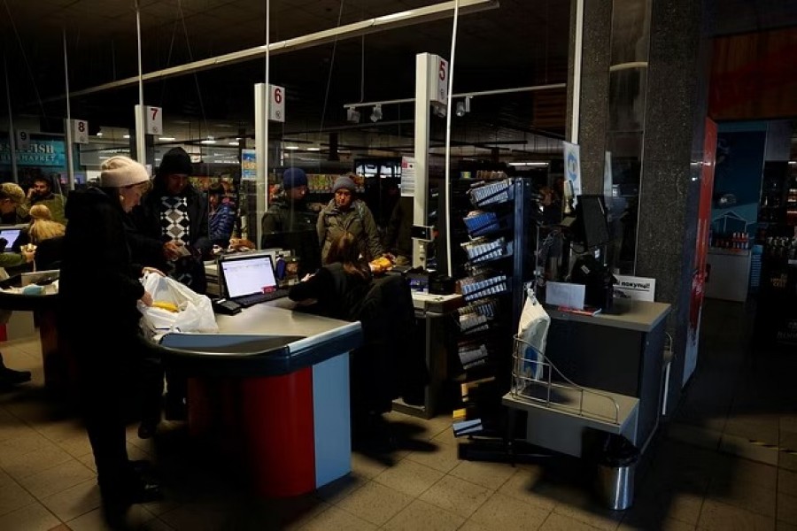 People shop in a supermarket as Kharkiv suffers an electricity outage, amid Russia's attack on Ukraine, in Kharkiv, Ukraine, October 17, 2022. REUTERS