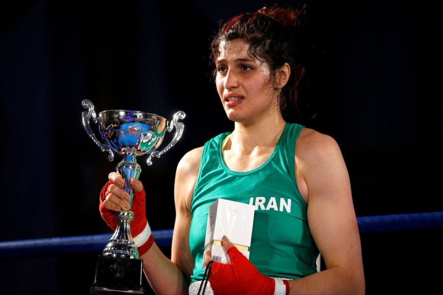 Sadaf Khadem is presented with the trophy after beating Anne Chauvin in their boxing match in Royan. Photograph: Stéphane Mahé/Reuters