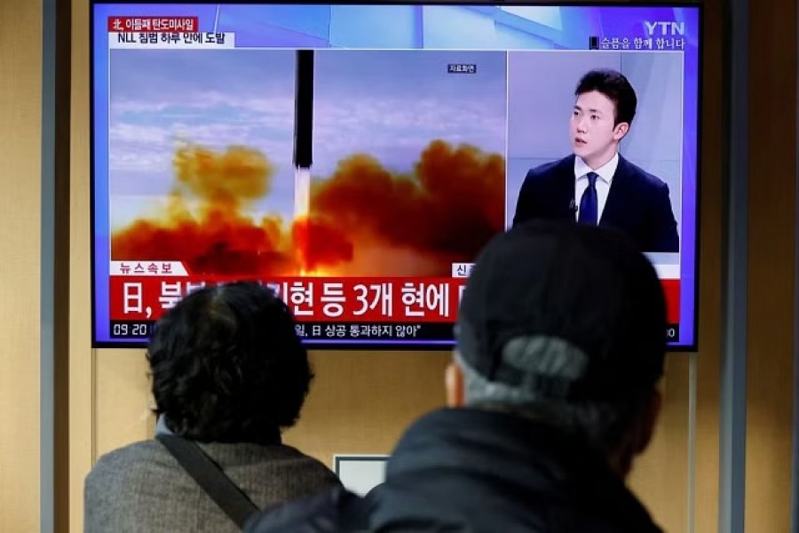 People watch a TV broadcasting a news report on North Korea firing a ballistic missile off its east coast, in Seoul, South Korea, November 3, 2022. REUTERS