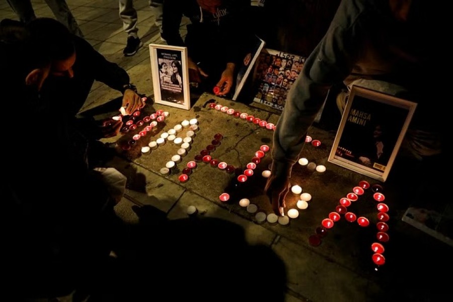 Demonstrators light candles during a protest following the death of Mahsa Amini in Athens, Greece, Oct 29, 2022.REUTERS