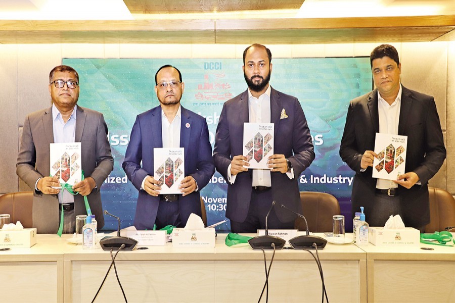 Deputy Governor of Bangladesh Bank Abu Farah Md. Nasser, DCCI President Rizwan Rahman, Director at SME and Special Programmes Department of Bangladesh Bank Md Jaker Hossain and General Manager of SME Foundation Md Nazeem Satter hold copies of a DCCI booklet on 'Easy Access to CMSME Financing' at a workshop titled 'Issues and Opportunities of CMSME Lending' organised by DCCI in the city on Saturday.