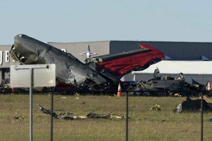 Debris from two planes that crashed during an airshow at Dallas Executive Airport lie on the ground Saturday, Nov. 12, 2022. (AP Photo/LM Otero)