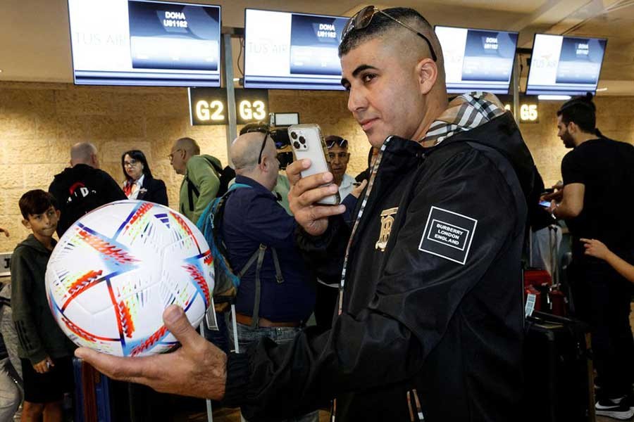 A football fan taking a photograph of a football, before boarding the first direct commercial flight between Israel and Qatar for the upcoming 2022 FIFA World Cup Qatar, at Ben Gurion International Airport near Tel Aviv in Israel on Sunday –Reuters photo