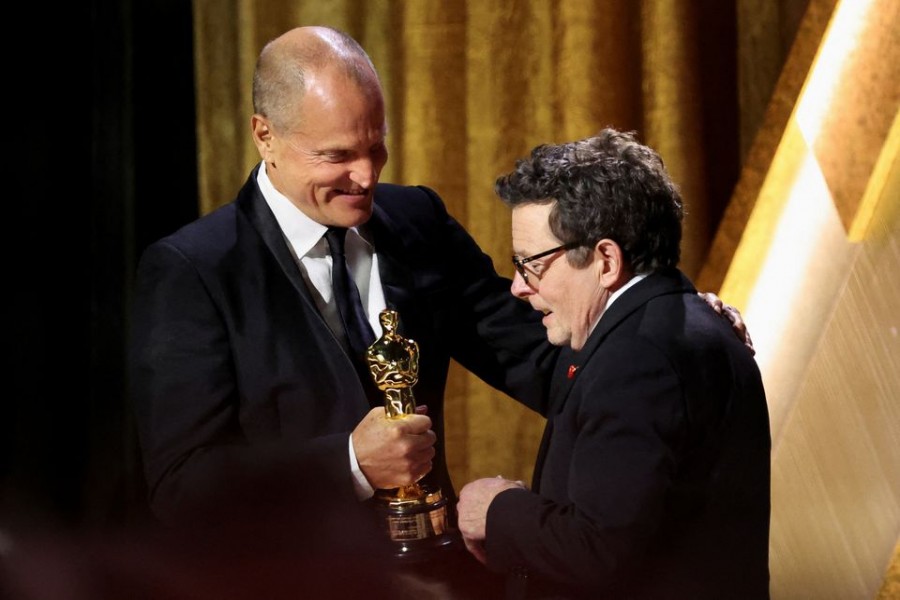 Actor Michael J. Fox receives the Jean Hersholt Humanitarian Award from Woody Harrelson at the 13th Governors Awards in Los Angeles, California, US, November 19, 2022. REUTERS/Mario Anzuoni