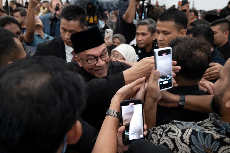 Malaysia's newly appointed Prime Minister Anwar Ibrahim greets his supporters as he leaves his news conference in Sungai Long, Selangor, Malaysia November 24, 2022. Office of Anwar Ibrahim/Afiq Hambali/Handout via REUTERS