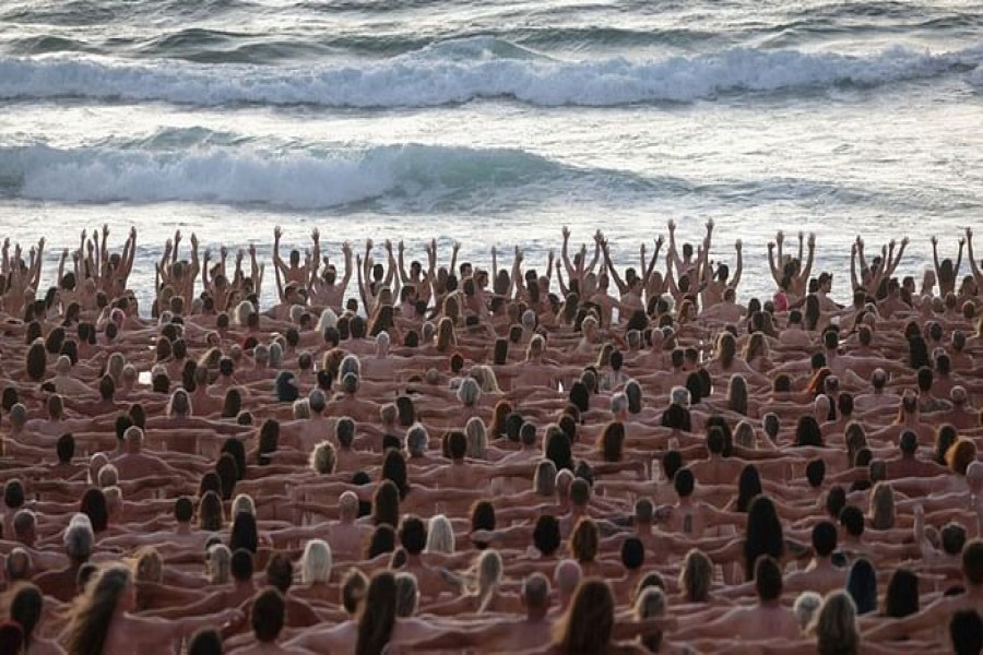 People stand naked as part of artist Spencer Tunick's art installation to raise awareness of skin cancer and encourage people to have their skin checked, at Bondi Beach in Sydney, Australia, November 26, 2022. REUTERS/Loren Elliott