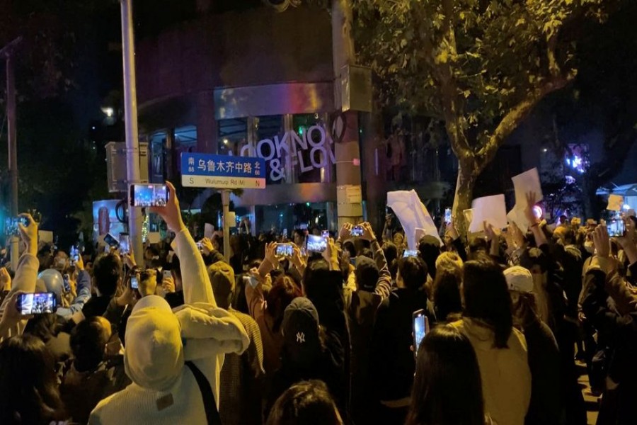 People take part in a protest against coronavirus disease (COVID-19) curbs in Shanghai, China, November 27, 2022, in this screen grab obtained from a social media video. Eva Rammeloo/via REUTERS