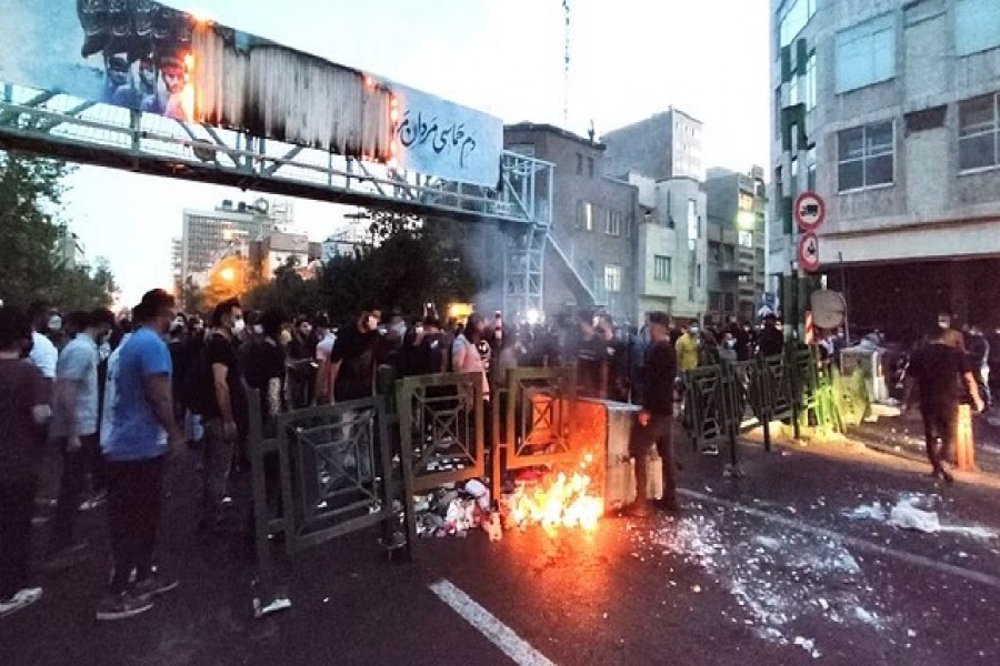 People light a fire during a protest over the death of Mahsa Amini, a woman who died after being arrested by the Islamic republic's "morality police", in Tehran, Iran, Sept 21, 2022. WANA (West Asia News Agency) via REUTERS