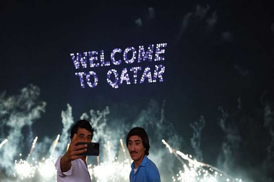 Soccer Football - FIFA World Cup Qatar 2022 - Doha, Qatar - December 2, 2022 General view as people take a selfie during the fireworks display at the corniche REUTERS/Susana Ver