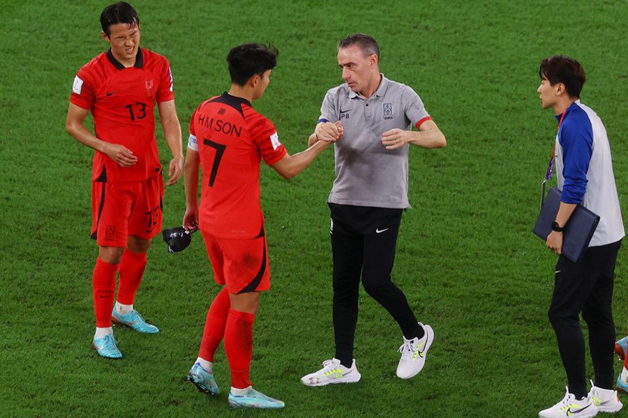 South Korea's Son Jun-ho, Son Heung-min and coach Paulo Bento look dejected after the match as South Korea are eliminated from the World Cup at Stadium 974 in Doha, Qatar on December 5, 2022 — Reuters photo