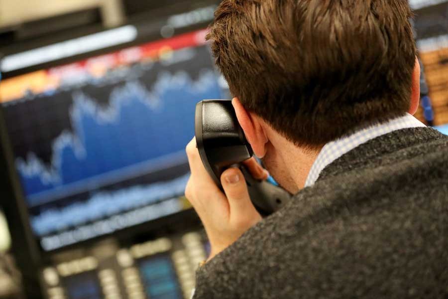 A broker looking at a graph on his computer screen on the dealing floor at ICAP in London on January 3 in 2018 –Reuters file photo