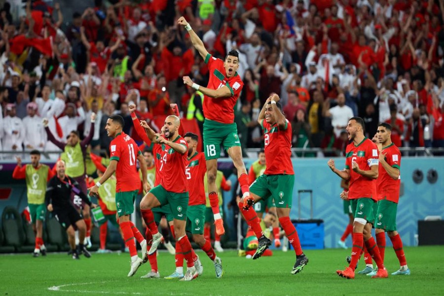 FIFA World Cup Qatar 2022 - Round of 16 - Morocco v Spain - Education City Stadium, Al Rayyan, Qatar - December 6, 2022 Morocco players celebrate after Achraf Hakimi scores the winning goal during the penalty shootout REUTERS/Wolfgang Rattay