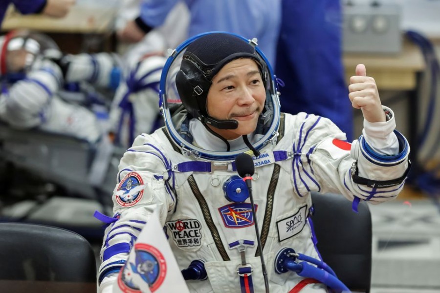 Japanese entrepreneur Yusaku Maezawa reacts as he speaks with his family after donning space suits shortly before the launch to the International Space Station (ISS) at the Baikonur Cosmodrome, Kazakhstan, December 8, 2021. REUTERS/Shamil Zhumatov