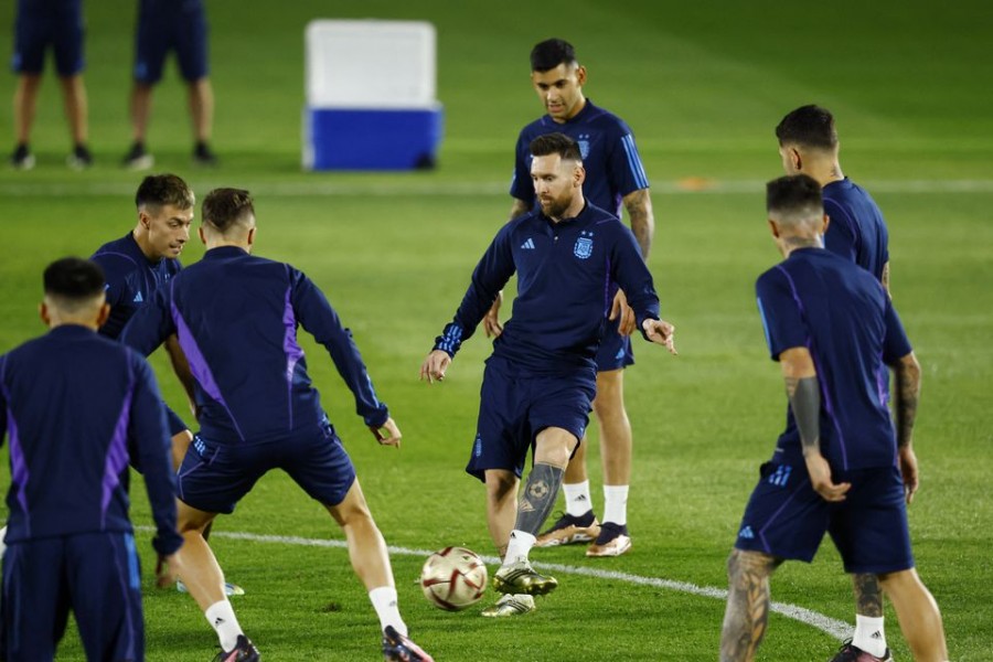 Argentina's Lionel Messi and Lisandro Martinez with Cristian Romero during training at Qatar University Training Site 3 in Doha, Qatar on December 12, 2022 — Reuters photo