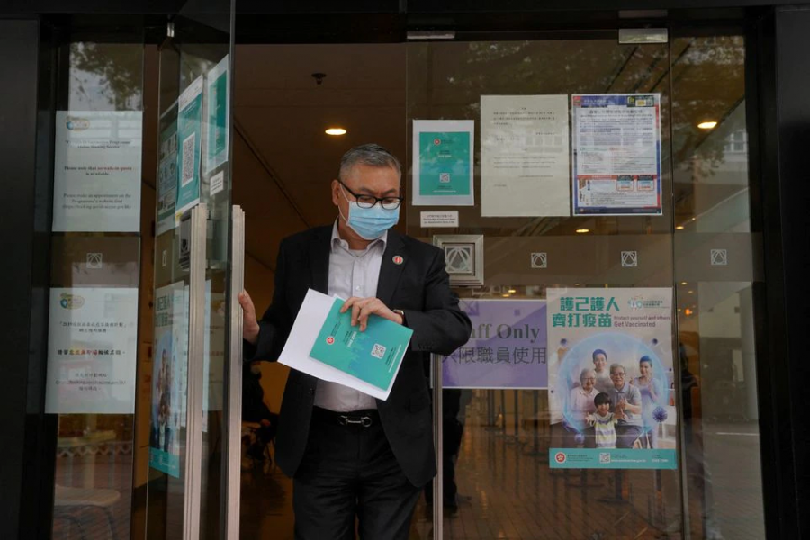 A man wearing a face mask leaves a vaccination centre administering Covid-19 vaccine, in Hong Kong, China on March 23, 2021 — Reuters/Files