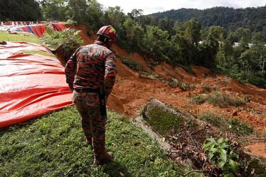 A rescue crew member checks the landslide area during a rescue and evacuation operation following a landslide at a campsite in Batang Kali, Selangor, Malaysia, Dec 17, 2022.REUTERS