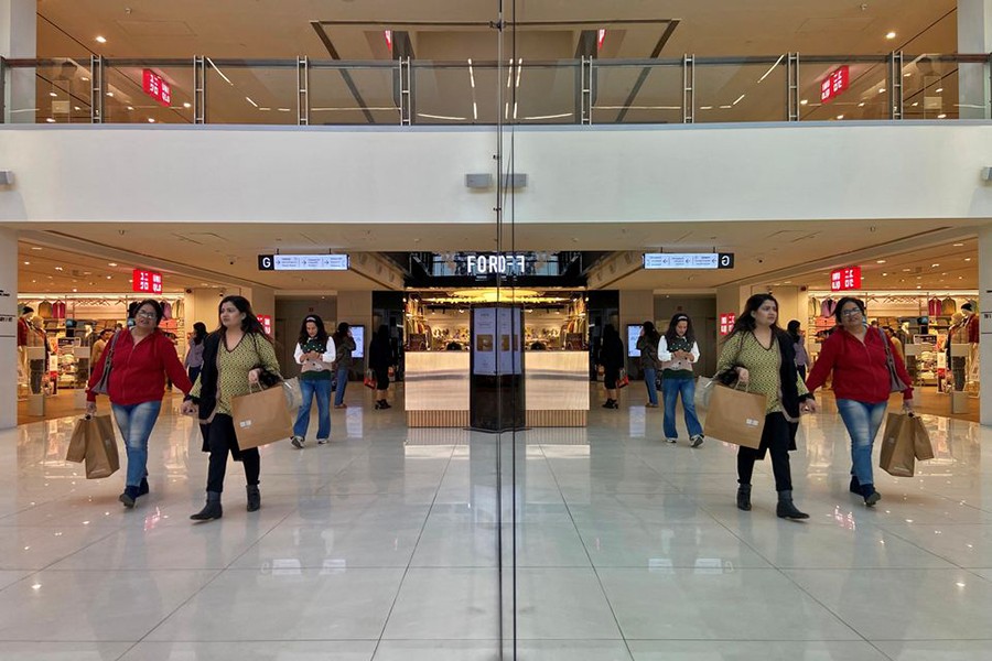 Shoppers are reflected in mirror inside a shopping mall in New Delhi, India on December 14, 2022 — Reuters photo