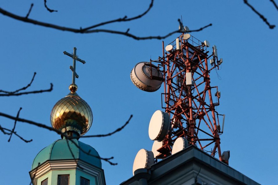 A view shows a communication tower next to an Orthodox church in Vladivostok, Russia November 9, 2022. REUTERS/Tatiana Meel