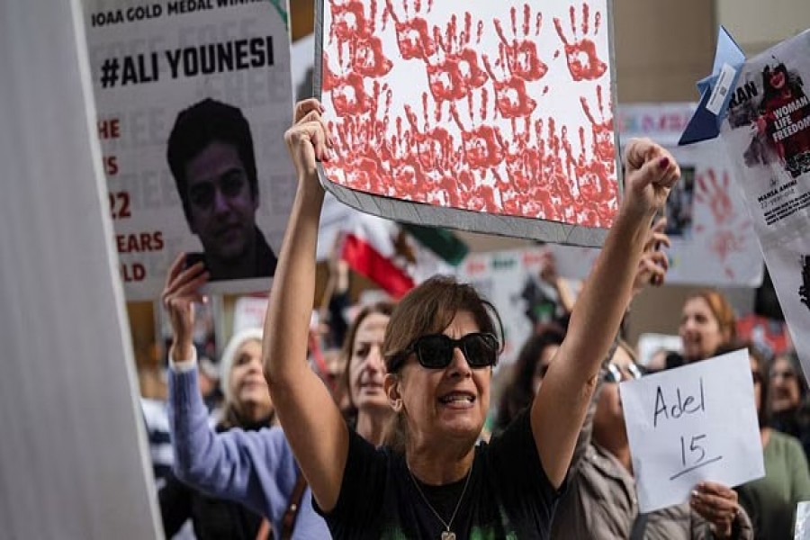 A woman chats during a protest against gender-based violence in Iran, in front of the United Nations Children's Fund (UNICEF) office in San Francisco, California, US, November 30, 2022. REUTERS/Amy Osborne