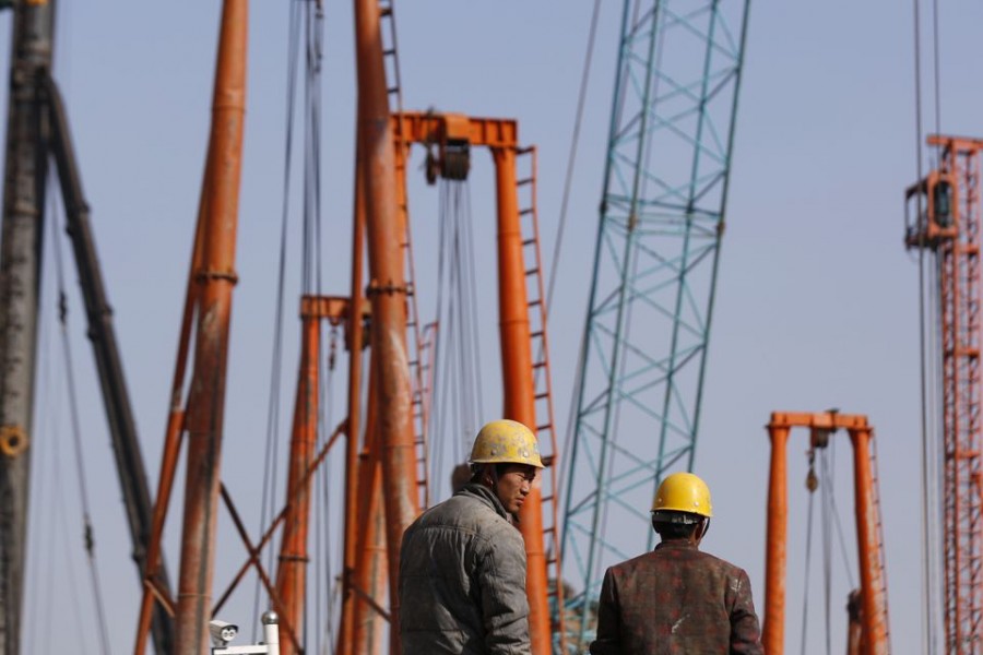 Labourers work at a construction site in Shanghai on December 16, 2014 — Reuters/Files