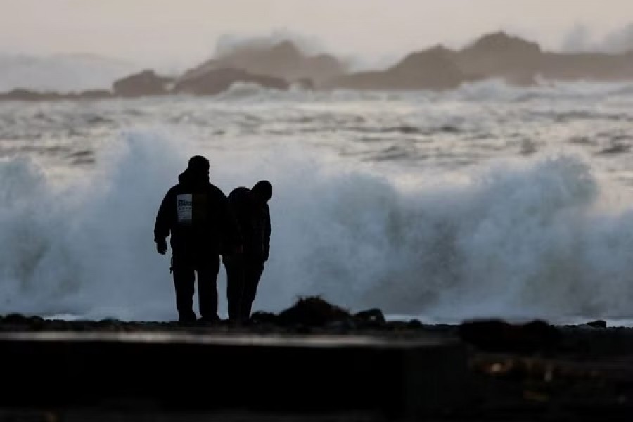 People look at items washed up on the beach from post-storm high surf at Van Damme Beach in Mendocino, California, US January 5, 2023. REUTERS