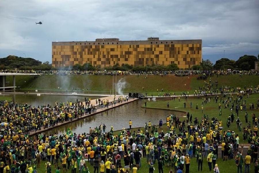 Supporters of Brazil's far-right former President Jair Bolsonaro who dispute the election of leftist President Luiz Inacio Lula da Silva gather near Brazil's Congress after protesters had invaded the building as well as the presidential palace and Supreme Court, in Brasilia, Brazil Jan 8, 2023. REUTERS