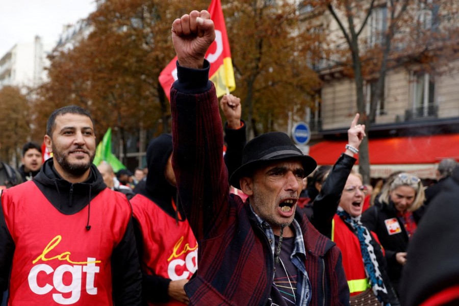 Protestors and French CGT labour union workers attend a demonstration as part of a nationwide day of strike and protests to push for government measures to address inflation, workers' rights and pension reforms, in Paris, France, September 29, 2022. REUTERS/Gonzalo Fuentes/File Photo