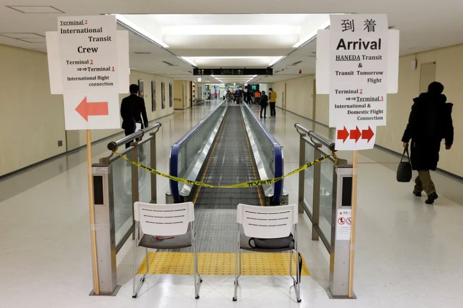 A passenger of a plane from Dalian in China, heads to the coronavirus disease (COVID-19) test area, upon his arrival at Narita international airport in Narita, east of Tokyo, Japan January 12, 2023. REUTERS/Kim Kyung-Hoon