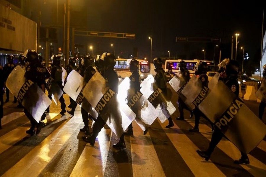 Riot police officers walk during the 'Take over Lima' march to demonstrate against Peru's President Dina Boluarte, following the ousting and arrest of former President Pedro Castillo, in Lima, Peru January 20, 2023. REUTERS/Pilar Olivares